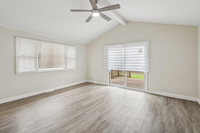 unfurnished room featuring wood finished floors, a ceiling fan, baseboards, and lofted ceiling with beams