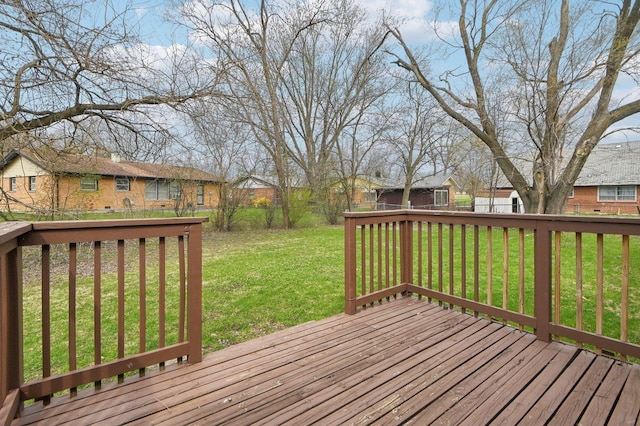 deck featuring a lawn, fence, and a residential view