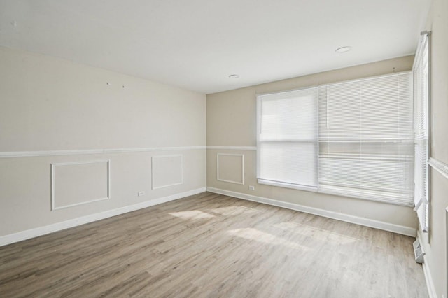 empty room with wood finished floors and baseboards