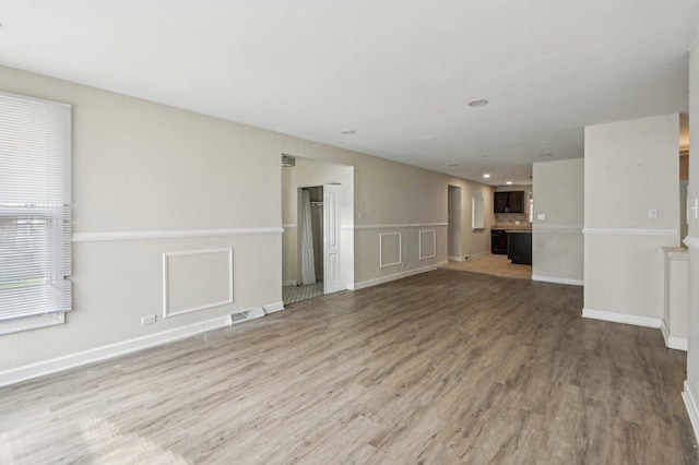 unfurnished living room featuring wood finished floors, visible vents, and recessed lighting
