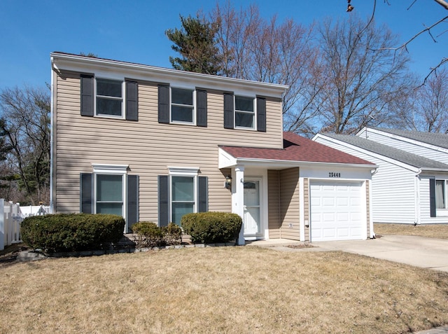 view of front of property with driveway, an attached garage, and a front lawn