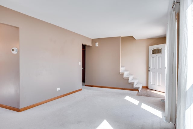 spare room with stairway, baseboards, and carpet floors