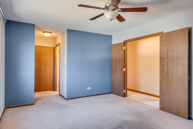 unfurnished bedroom featuring ceiling fan, baseboards, and carpet