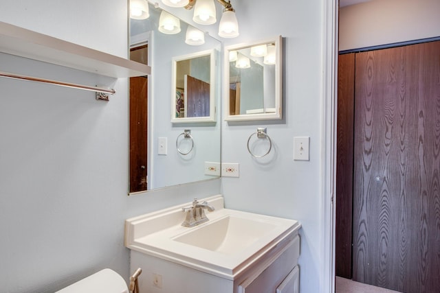 bathroom with toilet and vanity