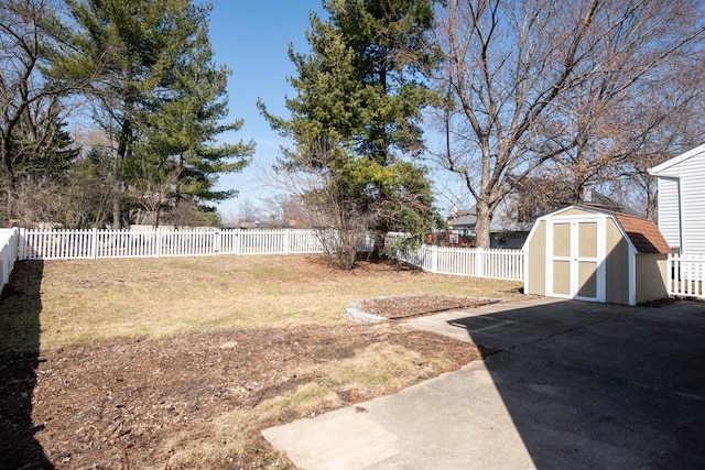 view of yard featuring an outbuilding, a fenced backyard, and a shed