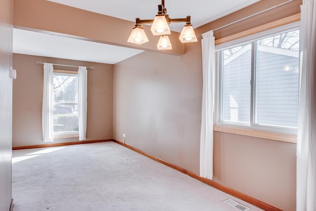 unfurnished room featuring visible vents, baseboards, and carpet floors