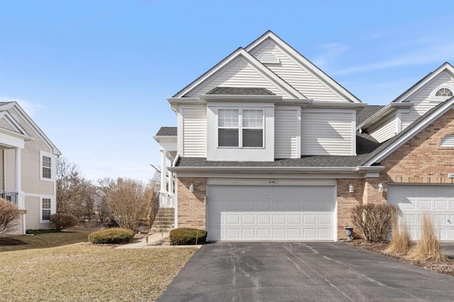 view of front of house with aphalt driveway, a garage, brick siding, and a shingled roof