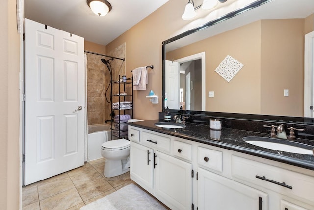 bathroom featuring a sink, toilet, double vanity, and tile patterned flooring