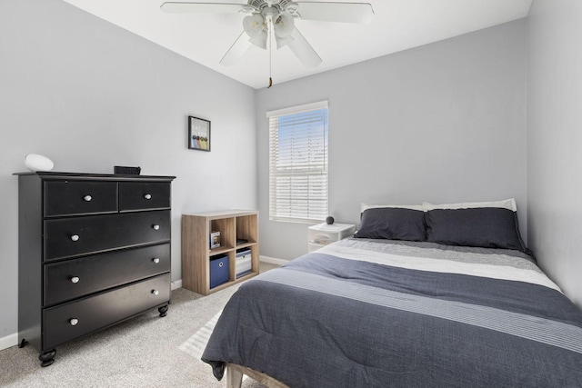 bedroom with baseboards, light colored carpet, and ceiling fan