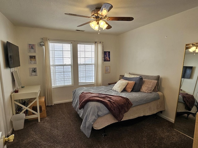 bedroom featuring carpet flooring, baseboards, visible vents, and ceiling fan