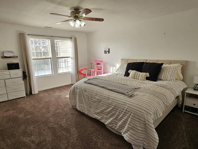 carpeted bedroom featuring a ceiling fan and visible vents