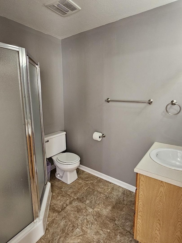 full bath with visible vents, a shower stall, vanity, and toilet