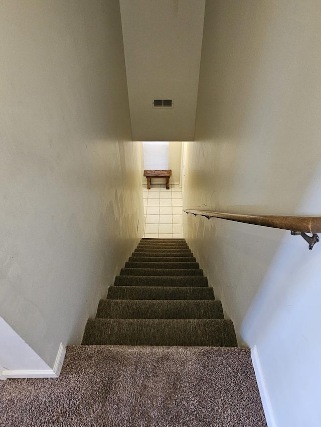 staircase featuring tile patterned flooring and visible vents