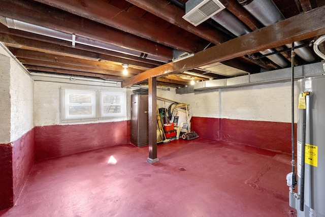 basement featuring visible vents and water heater