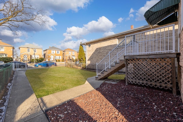 view of yard featuring stairway, fence, and a residential view