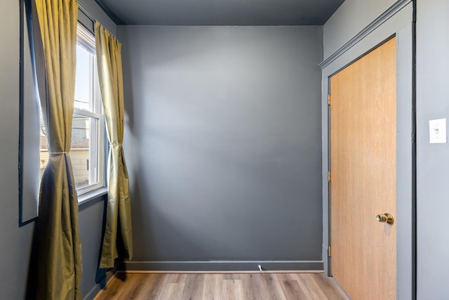 empty room featuring baseboards and wood finished floors