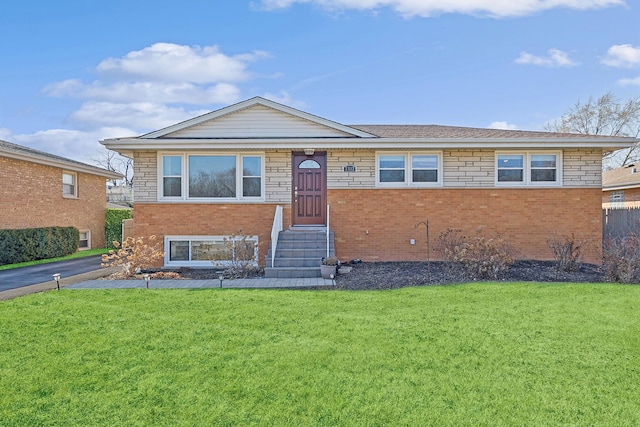 ranch-style home with a front lawn, brick siding, and stone siding