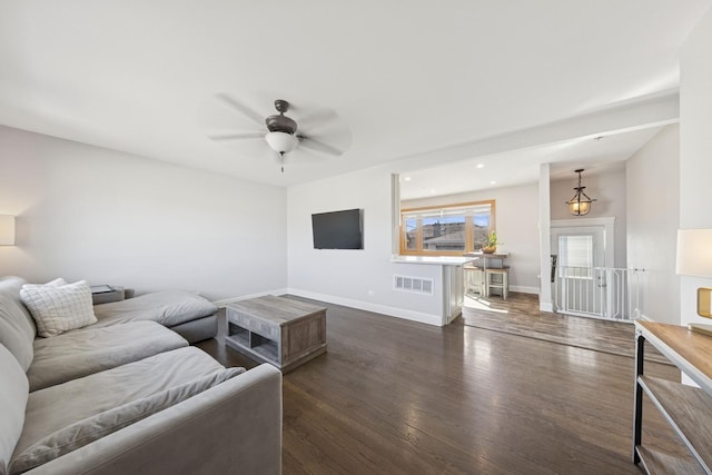 living room with visible vents, a ceiling fan, recessed lighting, baseboards, and dark wood-style flooring