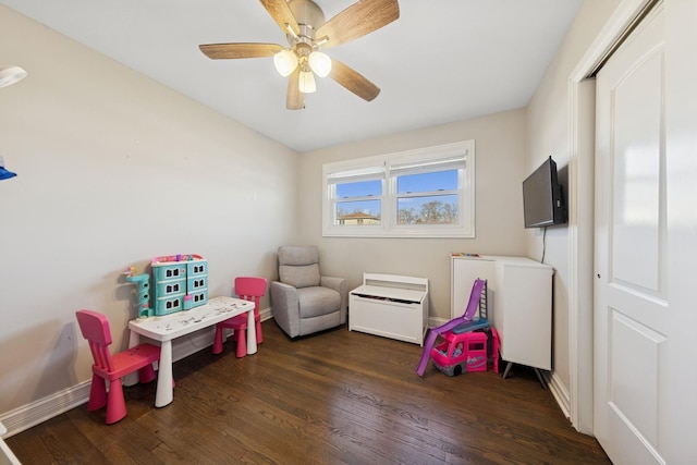 playroom with ceiling fan, baseboards, and wood finished floors