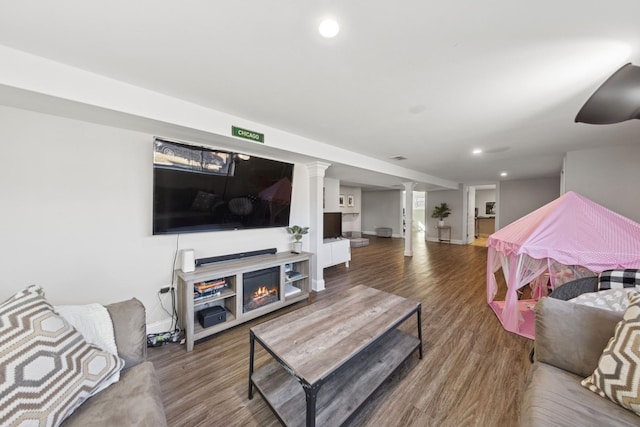 living room with recessed lighting, decorative columns, baseboards, and wood finished floors