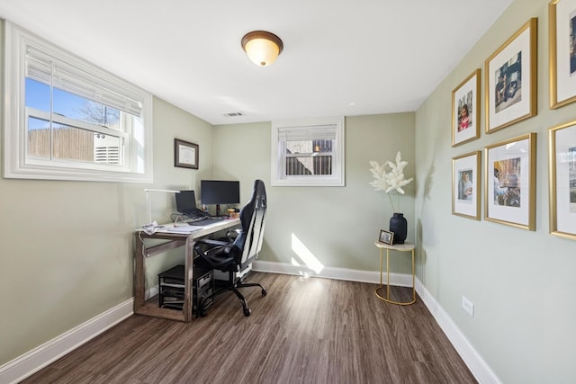 office featuring visible vents, baseboards, and wood finished floors