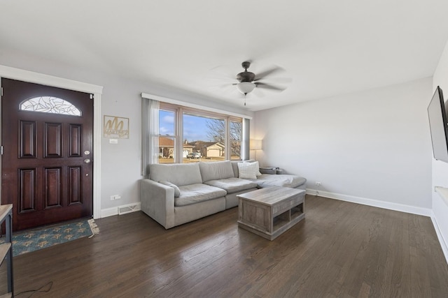 living room with visible vents, baseboards, dark wood-type flooring, and ceiling fan