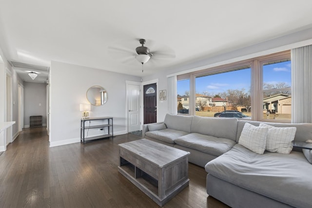 living area featuring dark wood finished floors, a ceiling fan, and baseboards