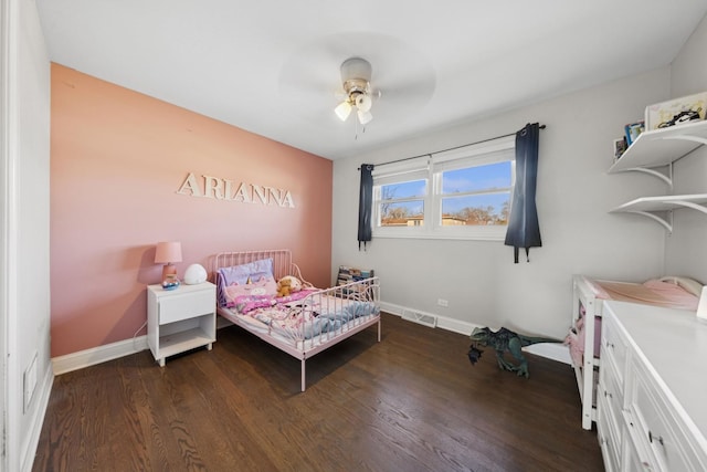 bedroom with visible vents, baseboards, dark wood-style floors, and a ceiling fan