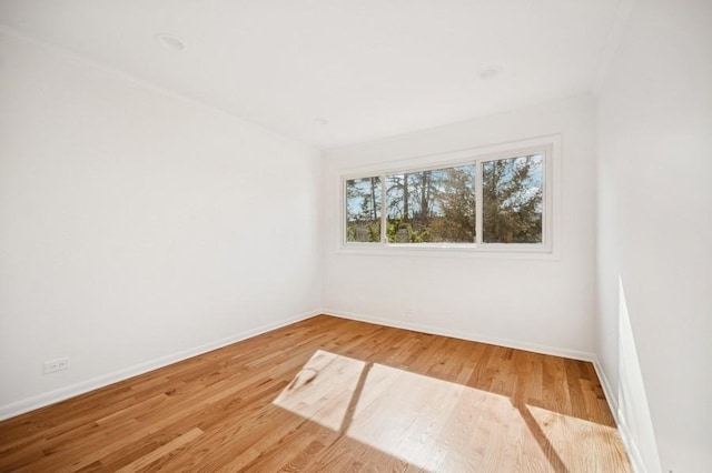 unfurnished room with wood finished floors and baseboards