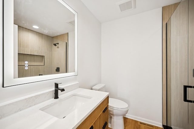 full bath featuring visible vents, toilet, a stall shower, and vanity