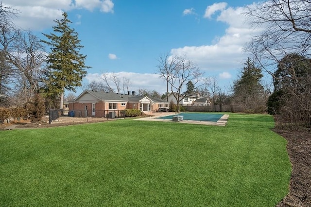 view of yard featuring a patio, fence, and a fenced in pool