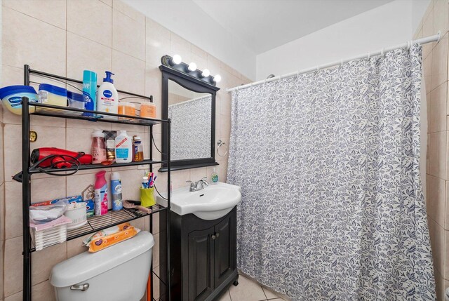 2434 W Pershing Rd, Chicago, IL 60632 - full bath with tile patterned flooring, tile walls, toilet, and vanity
