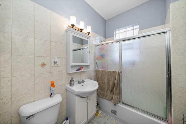 2434 W Pershing Rd, Chicago, IL 60632 - bathroom featuring tile patterned flooring, bath / shower combo with glass door, toilet, vanity, and tile walls