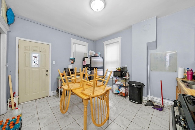 2434 W Pershing Rd, Chicago, IL 60632 - dining space featuring light tile patterned floors, baseboards, and plenty of natural light