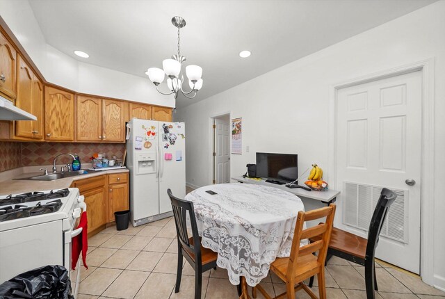 2434 W Pershing Rd, Chicago, IL 60632 - kitchen with white appliances, a sink, decorative backsplash, light countertops, and pendant lighting