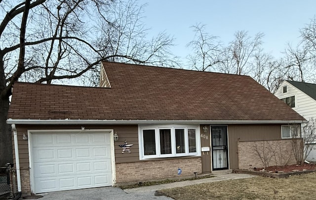 view of front of home with brick siding, an attached garage, and a shingled roof