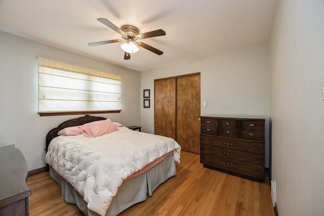 bedroom with a closet, light wood finished floors, and ceiling fan