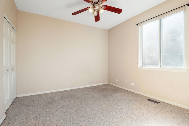 empty room with visible vents, baseboards, and carpet floors