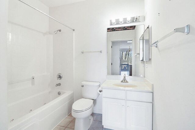 bathroom featuring vanity, tile patterned floors, toilet, and washtub / shower combination