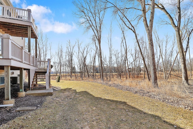 view of yard featuring stairs, a deck, and central AC unit