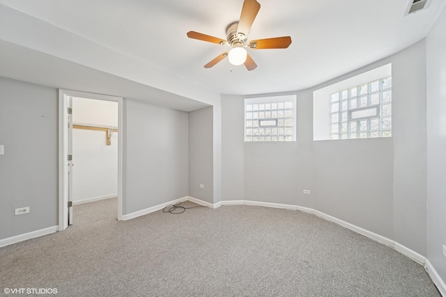 unfurnished bedroom featuring carpet, baseboards, visible vents, and a ceiling fan