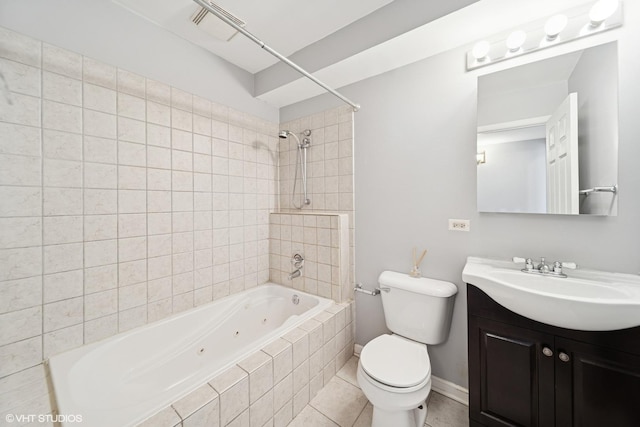 bathroom featuring toilet, a combined bath / shower with jetted tub, tile patterned flooring, baseboards, and vanity