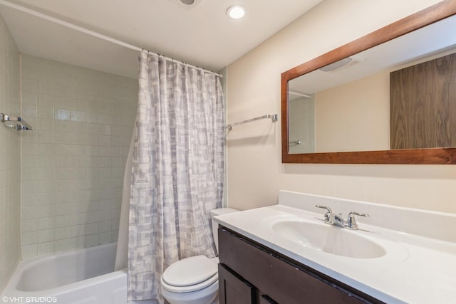 bathroom featuring vanity, toilet, and shower / bath combo with shower curtain