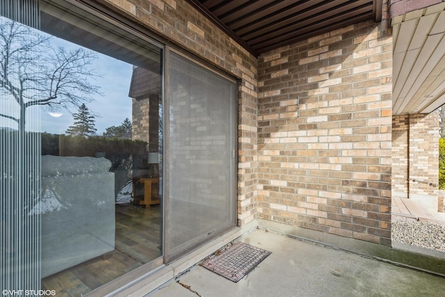 doorway to property featuring brick siding