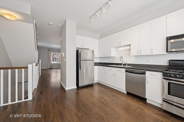 1616 S Indiana Ave Unit A2, Chicago, IL 60616 - kitchen featuring a sink, dark countertops, dark wood finished floors, appliances with stainless steel finishes, and tasteful backsplash