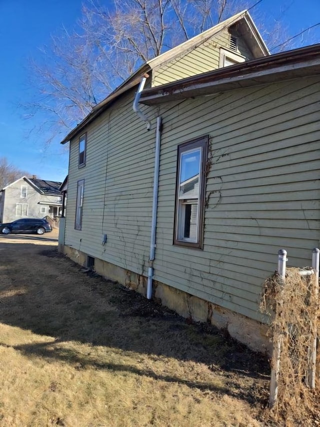 view of side of property with a lawn