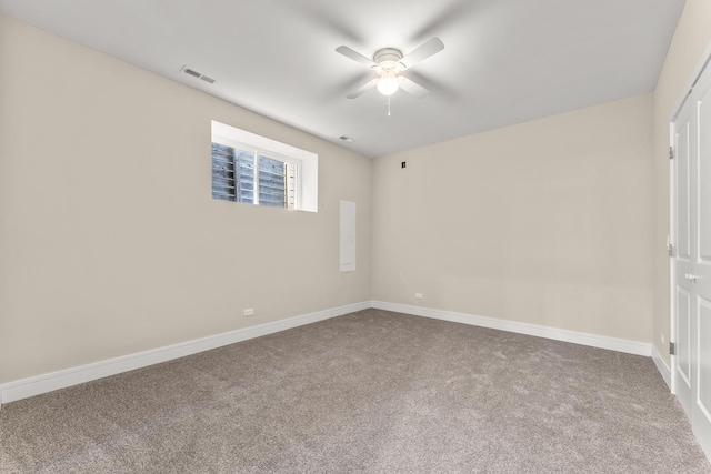 empty room with visible vents, carpet, baseboards, and ceiling fan