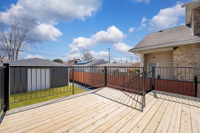 wooden deck with an outbuilding and a yard