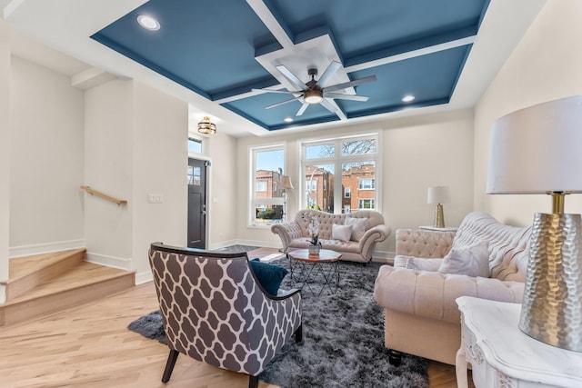 living area with baseboards, coffered ceiling, light wood finished floors, recessed lighting, and ceiling fan