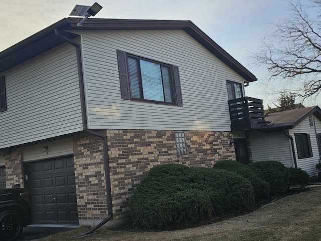 view of property exterior with an attached garage